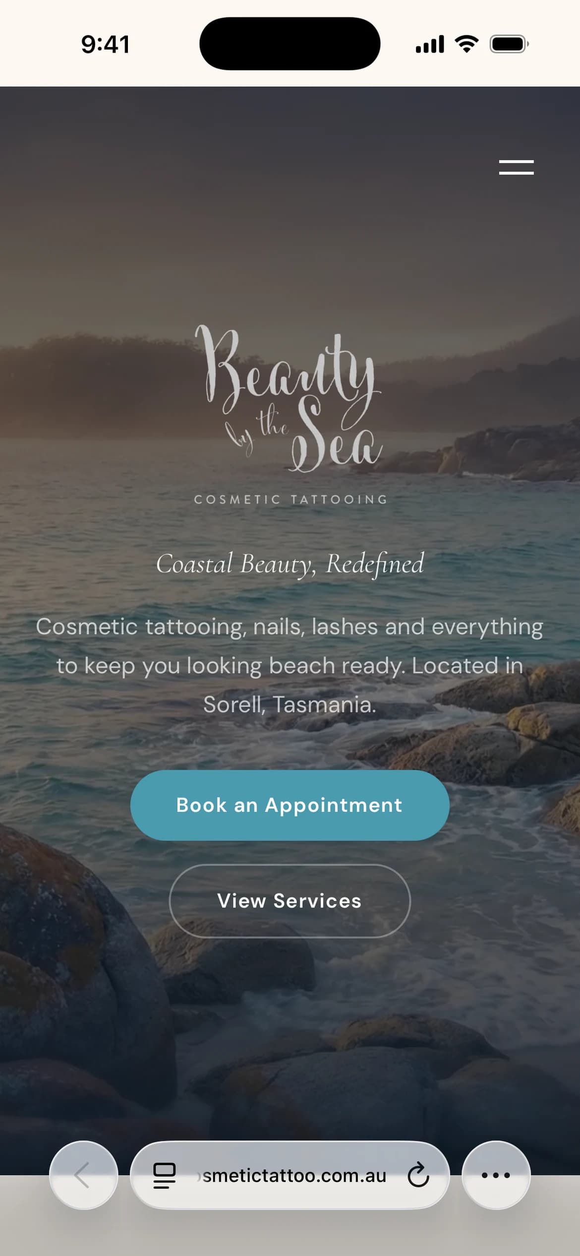 Beauty by the Sea homepage with a coastal photograph, studio logo and appointment and service links (mobile view)