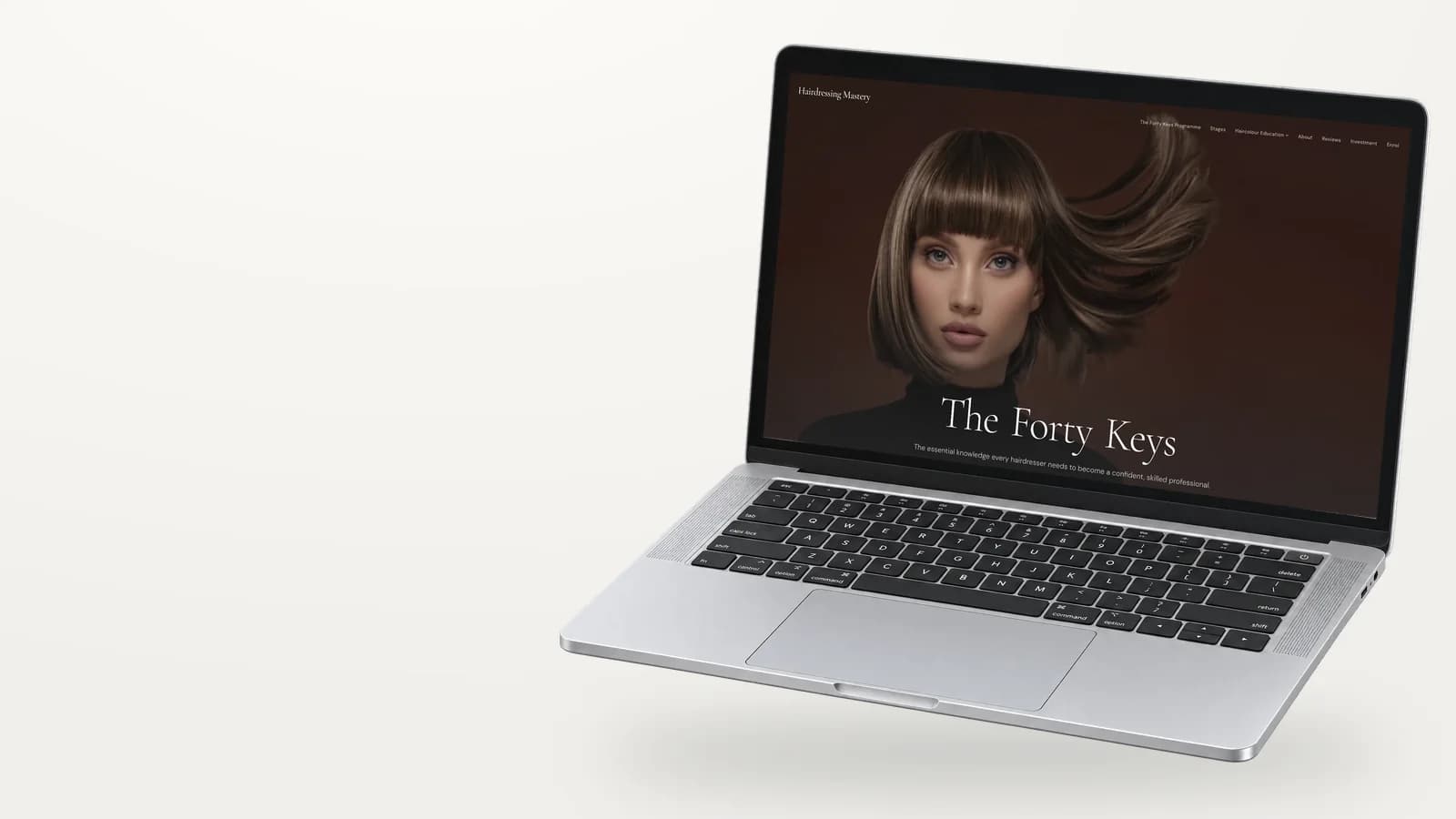 Hairdressing Mastery website on a laptop